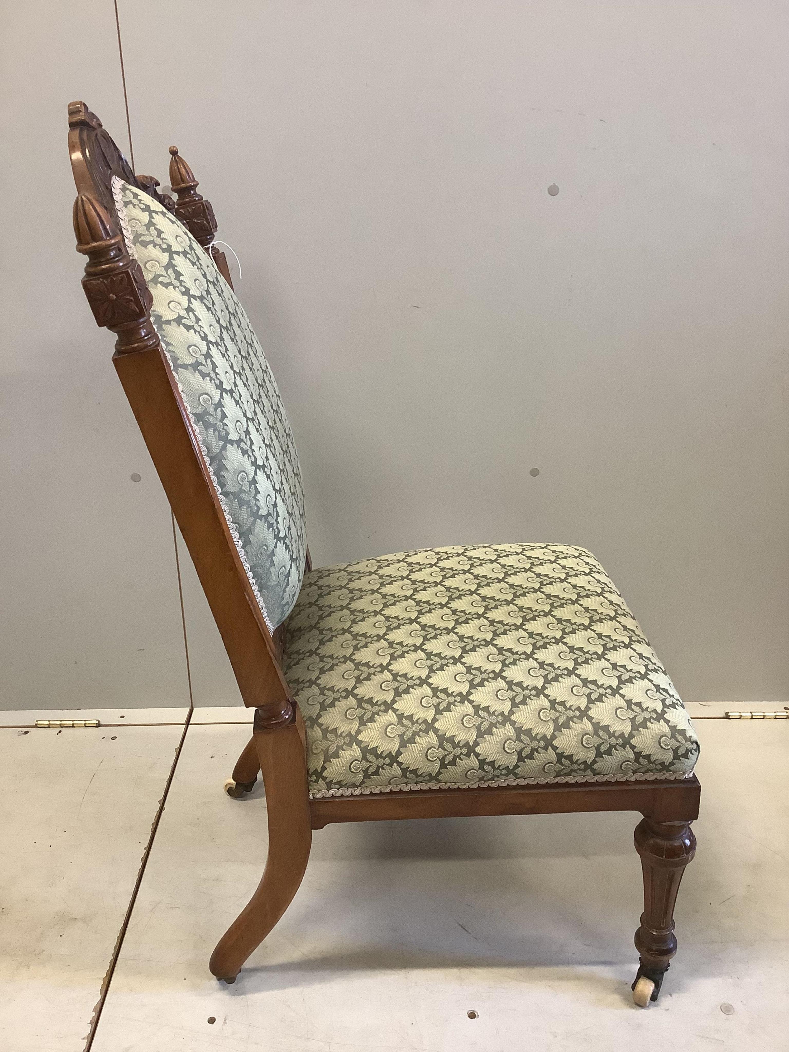 A Victorian walnut nursing chair, width 50cm, depth 58cm, height 101cm